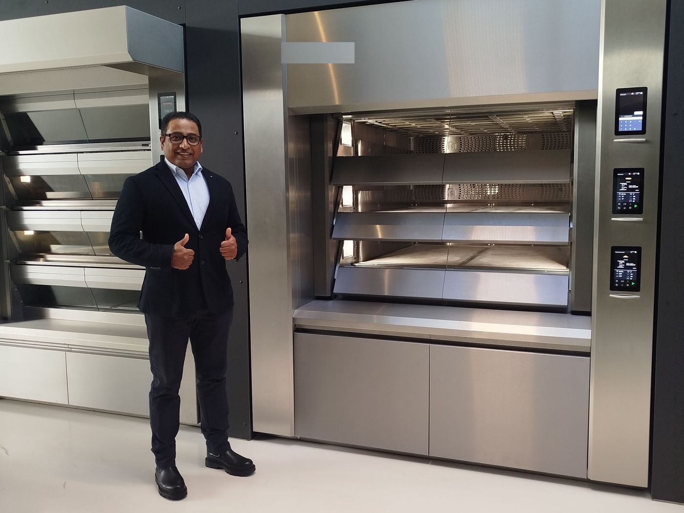 Ronald R. Seepersaud approving a professional deck oven in the showroom