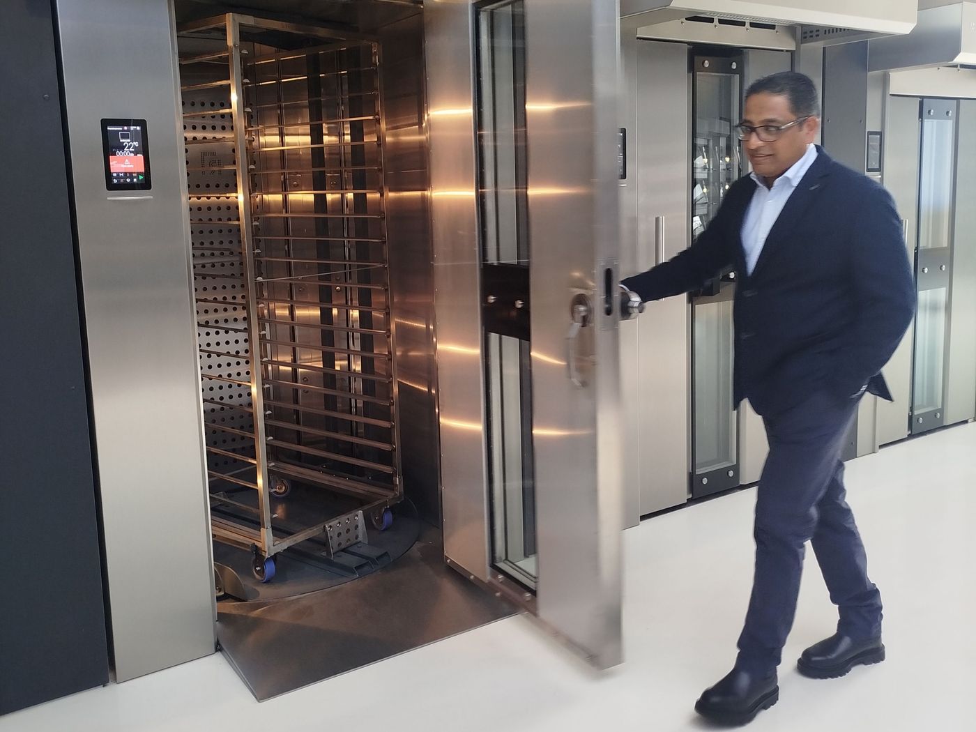 Ronald R. Seepersaud inspecting a rotating rack oven